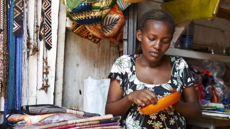 Pregnant woman working in a street market in Nairobi (Kenya).