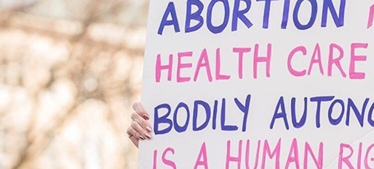 rally with signs for abortiion rights