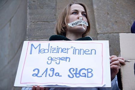 A woman holding a placard reading 'Medics against paragraph 219a StGB (for Criminial Code)' participates in a demonstration for the right of Sexual Self-determination in Berlin, Germany, 26 January 2019. A protest was held to rally for the abolition of criminal codes 218 and 219a. Paragraph 218 criminalizes those who perform abortions, paragraph 219a criminalises those who advertise abortions.
