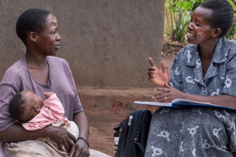 Two African women talking to each other as one holds a baby Building Rights-Based Accountability for SRHR