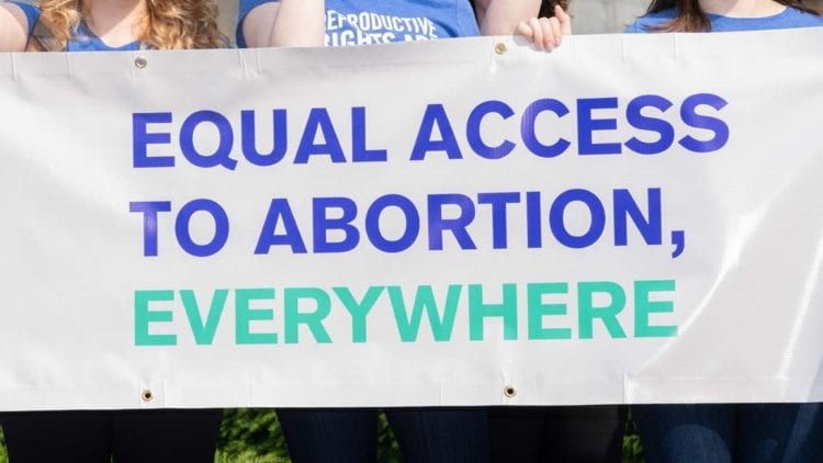 banner with the words "equal access to abortion, everywhere"