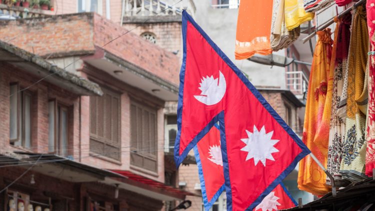 Nepal flag in community setting cropped