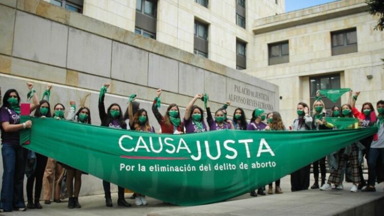 Women in Colombia with Causa Justa banner