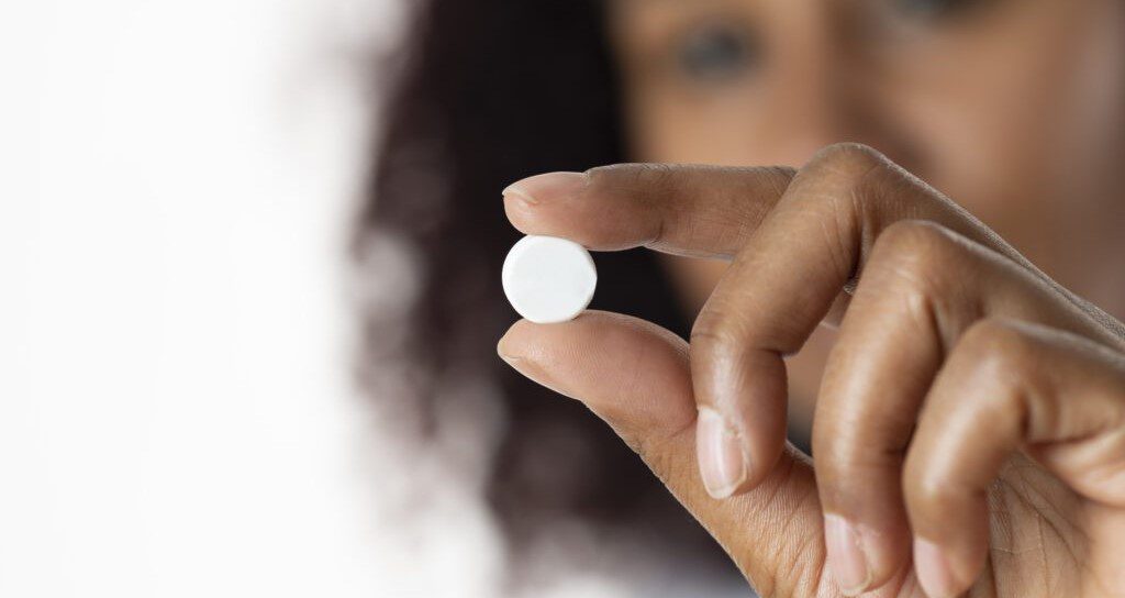 woman holding pill cropped medication abortion