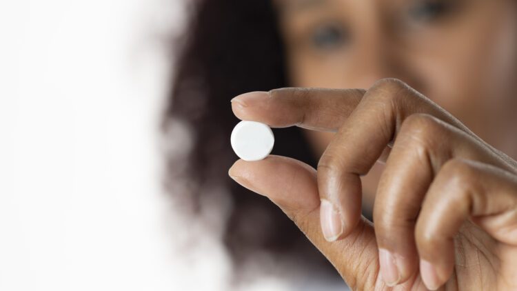 medication abortion, woman holding pill