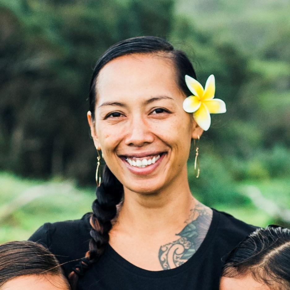 Headshot of Kawehi Ku'ailani, plaintiff in Kaho‘ohanohano v. State of Hawai‘i, wearing a flower in her hair against a verdant background.