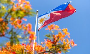 Philippines flag with flowering tree in background