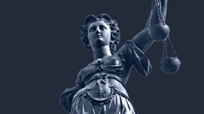 Lady Justice statue against blue background