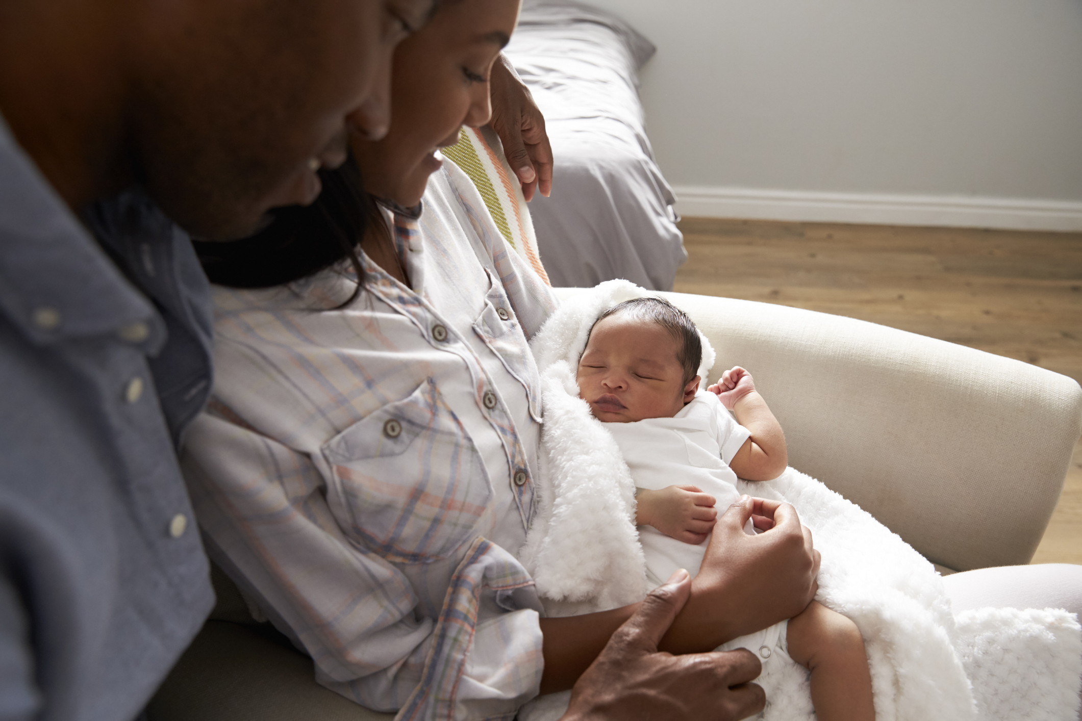 Couple smiling at their newborn baby