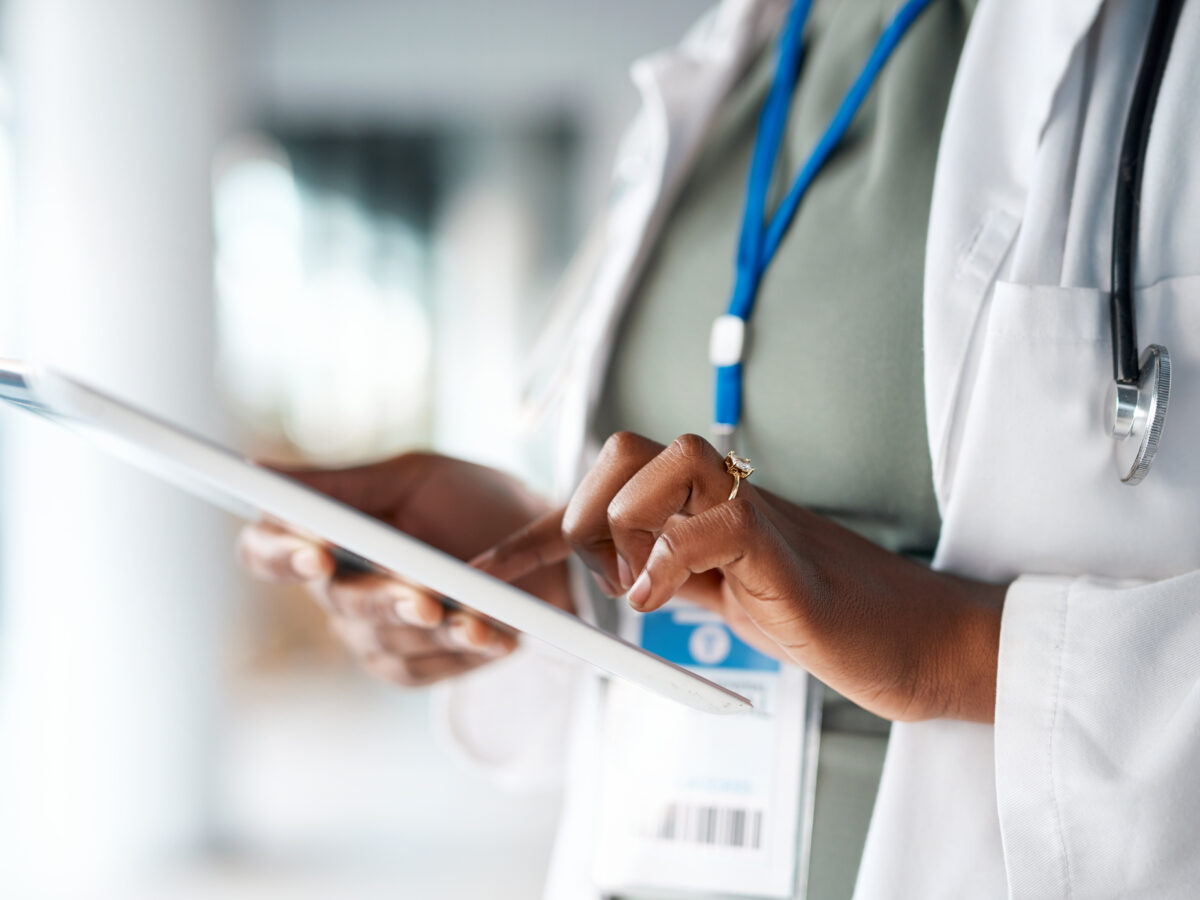 Doctor holding tablet in a hospital setting