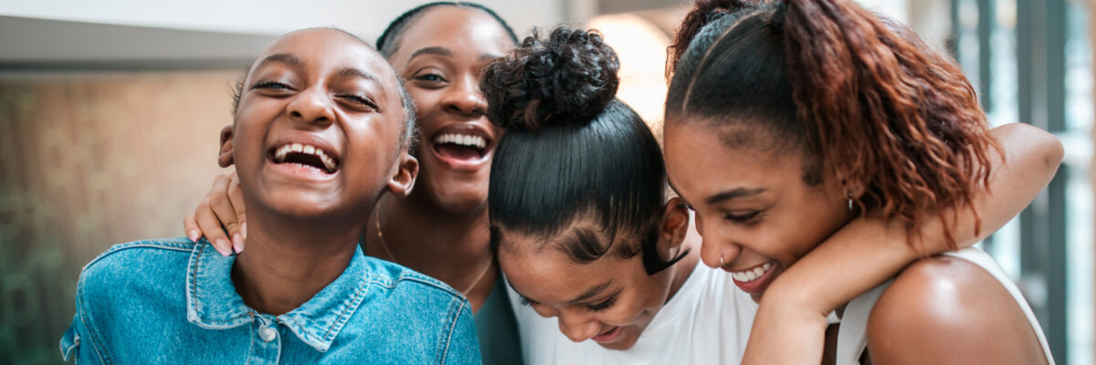 young women laughing and hugging