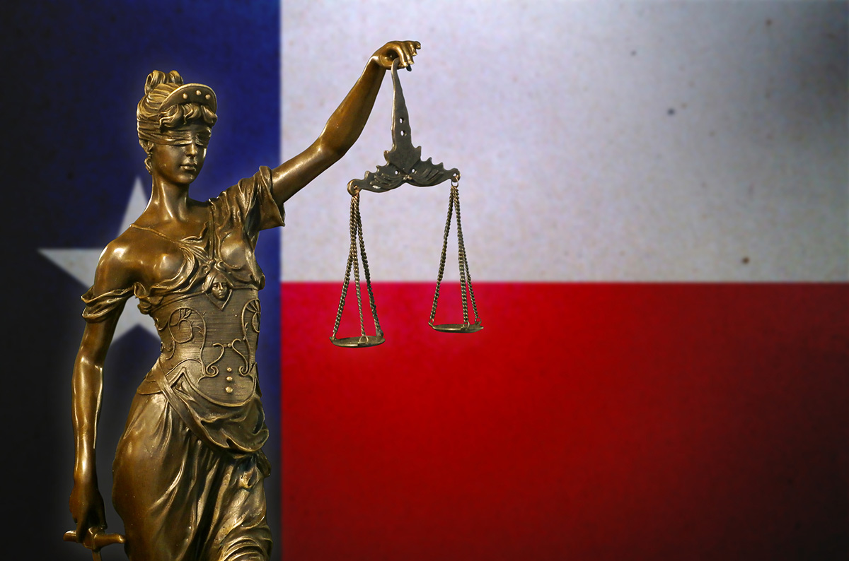 Lady Justice in front of a Texas flag